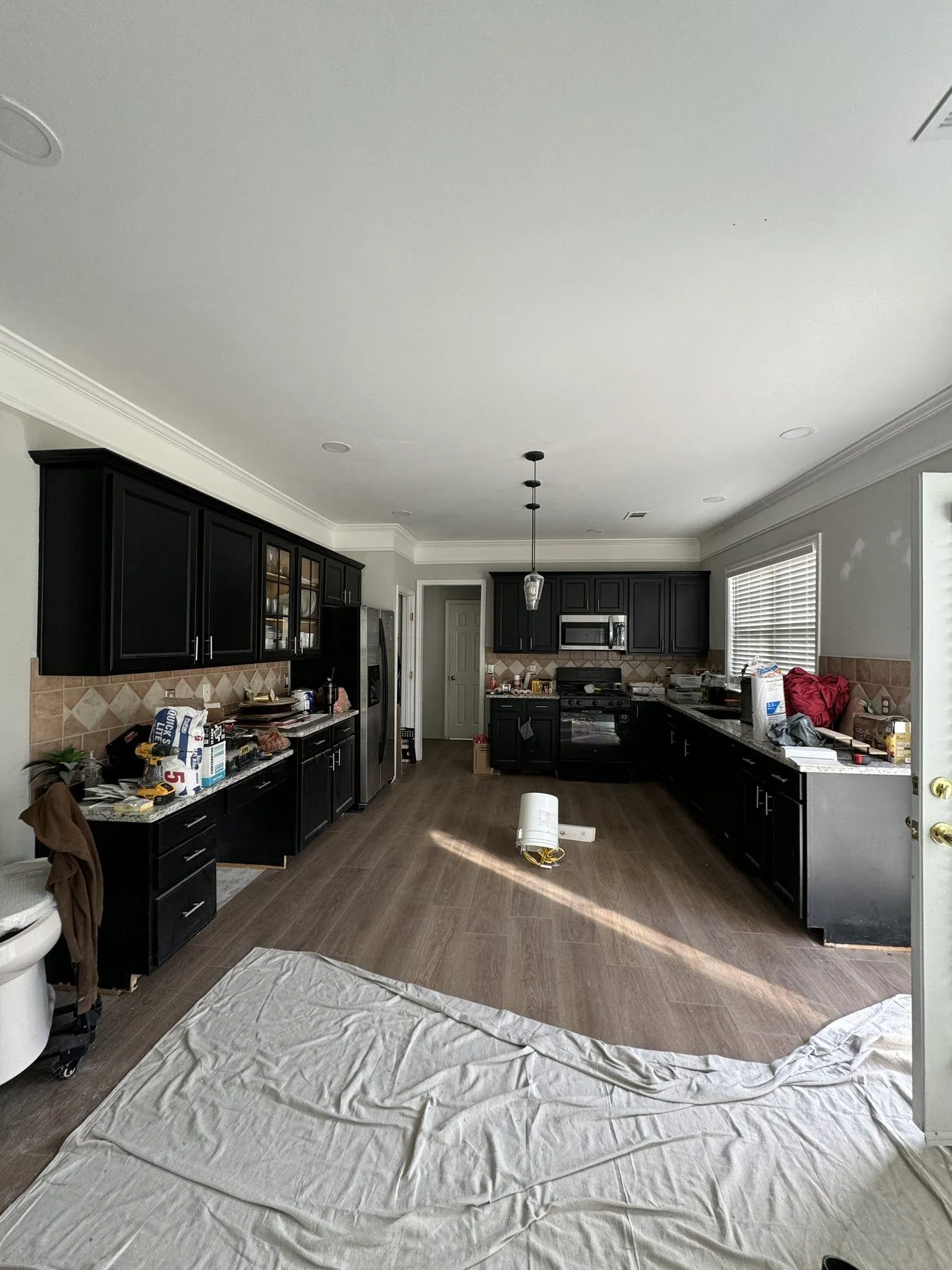 Before — espresso cabinets and diagonal beige tile