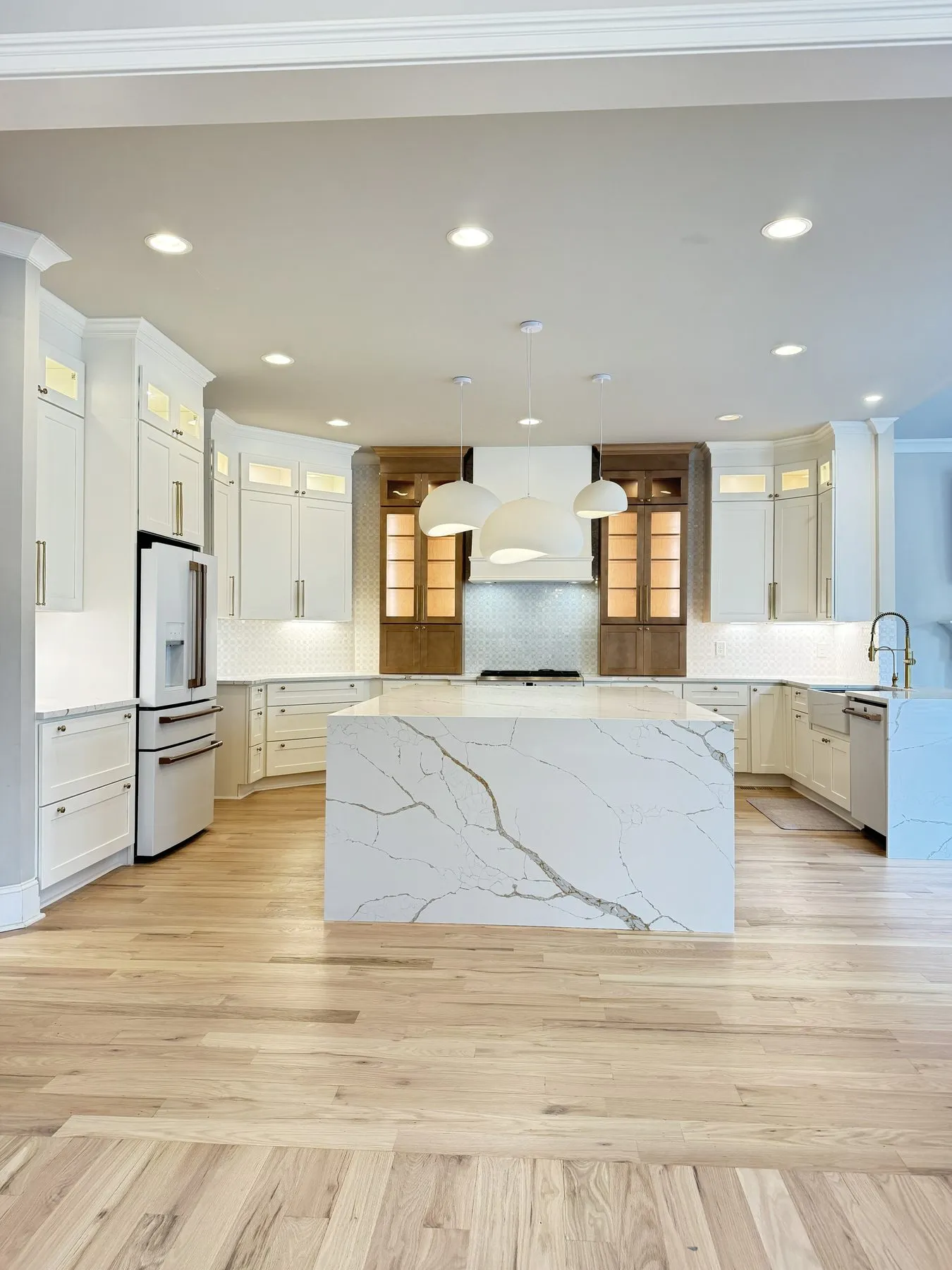 The finished kitchen — cream cabinets and the new island